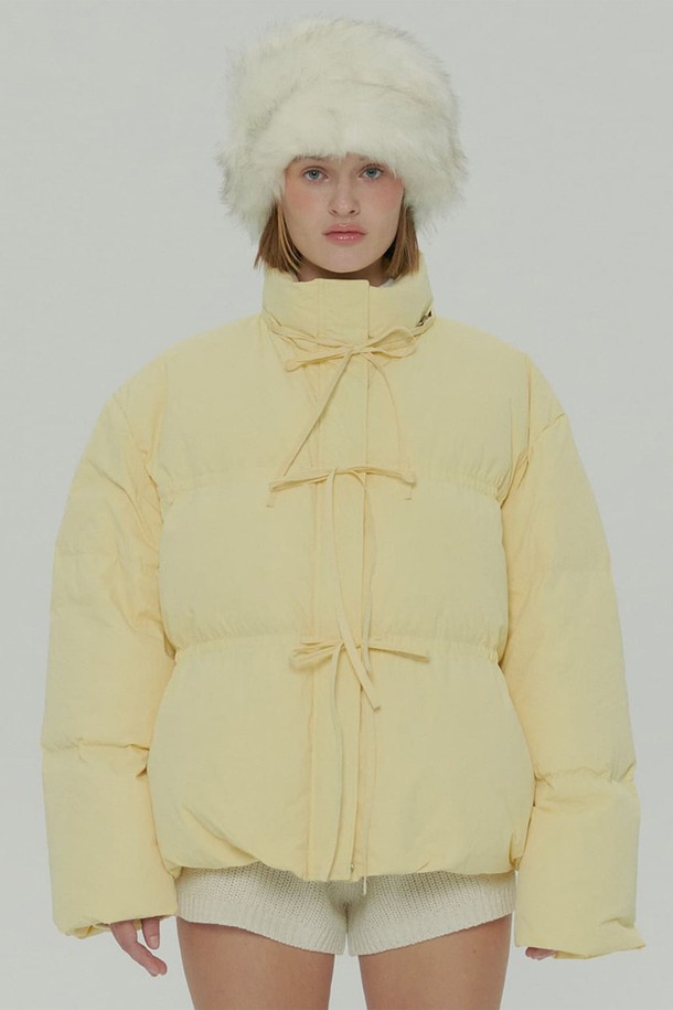 옐로우 컬러의 스트랩 다운 재킷입니다. 여성 의류로, 겨울철 캐주얼 및 미니멀 스타일 연출에 적합합니다. 크롭 기장에 오버핏으로 디자인되었으며, 부드러운 폴리에스테르 소재로 제작되어 편안한 착용감을 선사합니다. 스트랩 디테일과 퍼프 소매가 특징이며, 여행룩으로도 활용하기 좋습니다. 
