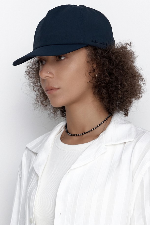 **UC 5패널 윙 캡 (네이비)**

부드러운 촉감의 나일론, 면 혼방 소재로 제작된 네이비 컬러의 캡모자입니다. 얇은 두께감으로 봄, 여름에 착용하기 좋으며, 5 패널 구조와 트러커 캡 디자인이 특징입니다. 13cm 모자 깊이와 6.5~7cm 챙 넓이로 편안한 착용감을 제공하며, 사이즈 조절이 가능합니다. 실버톤 시그니처 로고 자수와 버클 디자인으로 포인트를 더했습니다. 동네 마실룩, 산책룩, 여행룩, 캐주얼, 미니멀, 시티보이 스타일을 즐기는 분들께 추천합니다.
