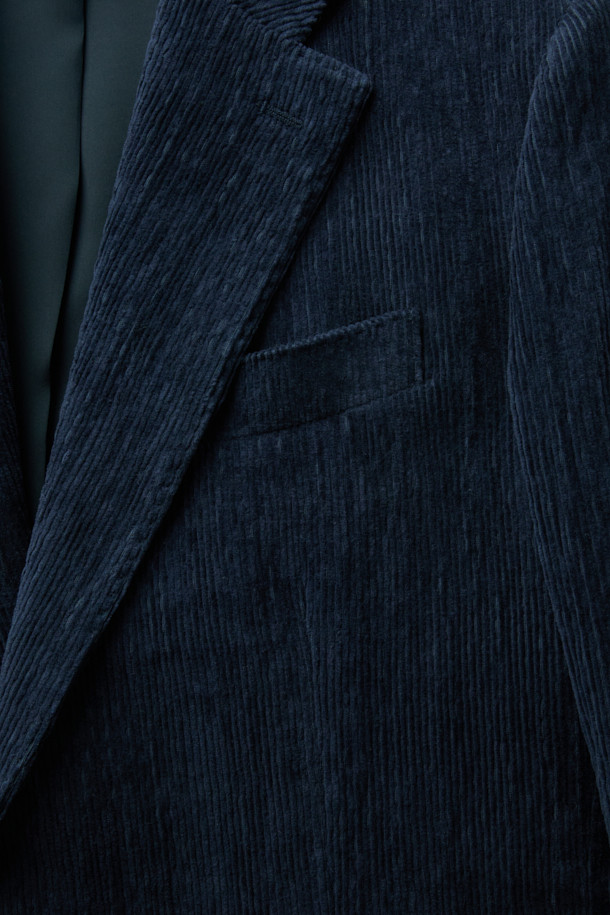 파브리카 코튼스트레치 코듀로이 셋업 재킷은 남성 고객을 위한 클래식 스타일의 셋업 자켓입니다. 네이비 컬러의 코듀로이 소재에 면을 혼방하여 제작되었으며, 봄, 가을에 착용하기 적합합니다. 슬림핏 싱글버튼 디자인으로, 비즈니스 캐주얼, 출근룩, 모임룩 등 다양한 TPO에 활용 가능합니다. 스트레치 기능이 더해져 편안한 착용감을 선사합니다.
