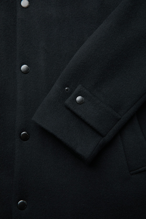 MOVERE X ROLIAT 발마칸 코트는 세미 루즈핏으로 제작되어 편안하면서도 세련된 실루엣을 연출합니다. 울과 캐시미어 혼방 소재로 제작되어 부드러운 촉감과 뛰어난 보온성을 제공하며, 가을과 겨울에 착용하기 좋습니다. 블랙 컬러의 무지 디자인은 클래식하면서도 미니멀한 스타일을 완성하며, 출근룩, 오피스룩, 모임룩 등 다양한 TPO에 활용 가능합니다. 래글런 소매, 히든 포켓, A라인 실루엣, 단단한 카라 디테일이 돋보이며, 스냅 버튼 여밈 방식으로 간편하게 착용할 수 있습니다. 롱 기장의 발마칸 코트로 시크한 스타일을 연출해보세요.
