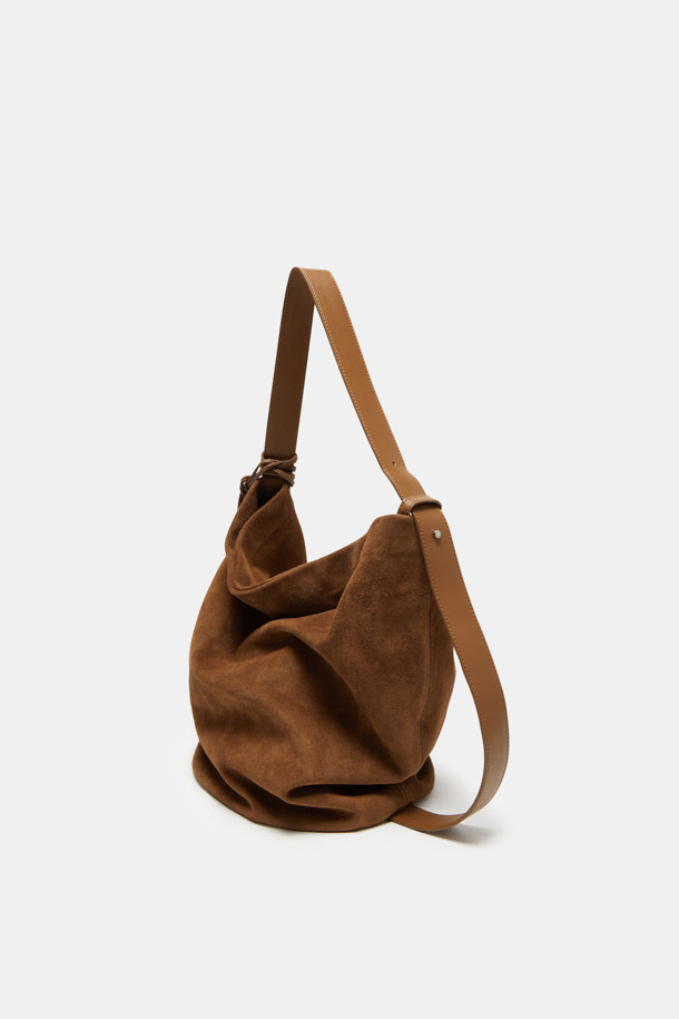 "Haru Shoulder 24 Suede(하루 숄더 24 스웨이드)"는 스웨이드와 가죽 소재의 조화가 돋보이는 미디엄 사이즈 숄더백입니다. 블랙과 브라운 두 가지 색상으로 출시되었으며, 은색 하드웨어 참 장식이 시크함을 더합니다. 탈부착 및 길이 조절 가능한 스트랩으로 2way 착용이 가능하며, 반원 형태의 디자인과 자연스러운 드레이핑 실루엣이 특징입니다. 

13인치 아이패드 수납이 가능하며, 내부에 포켓이 있어 실용성을 높였습니다. 깔끔한 외관과 마그네틱형 잠금 방식으로 데이트룩, 쇼핑룩 등 일상 용도로 폭넓게 활용할 수 있으며, 클래식, 미니멀, 시크 스타일을 연출하기에 좋습니다. 아이폰/아이패드/맥북 프로 수납이 가능하고, 사용할수록 자연스러운 에이징 효과를 느낄 수 있습니다.
