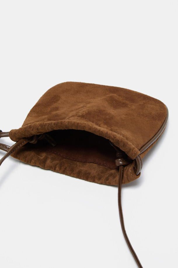 Bilo Cross Charm (비로 크로스 참)은 스웨이드와 합성가죽 소재의 미니 사이즈 복주머니 가방입니다. 브라운 컬러로 클래식, 미니멀, 캐주얼 스타일에 잘 어울리며, 데이트룩, 쇼핑룩에 포인트를 더할 수 있습니다. 조임용 끈으로 잠그는 방식으로, 내부 수납공간이 있어 에어팟, 립스틱 등 소지품을 안전하게 보관할 수 있습니다. 크로스백 또는 참 백으로 활용 가능하며, 길이를 조절하여 다양한 스타일로 연출할 수 있습니다. 다른 가방에 참으로 활용하여 나만의 개성을 표현해보세요.
