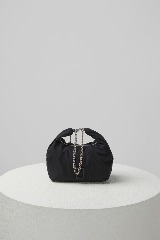 플러피 팝(Fluffy pop) 크로스 20은 여성용 크로스백으로, 미디엄 사이즈의 블랙 나일론 소재 무지 가방입니다. 반원 모양에 체인 장식이 더해져 미니멀, 클래식, 시크한 스타일을 연출합니다. 생활 방수 기능과 탈부착 가능한 스트랩으로 실용성을 높였으며, 자연스러운 주름 라인이 특징입니다. 내부에는 지퍼 포켓 1개와 일반 포켓 1개가 있어 수납이 용이하며, 브라스 소재 하드웨어가 고급스러움을 더합니다. 출근룩, 모임룩, 데이트룩 등 다양한 TPO에 활용 가능합니다.
