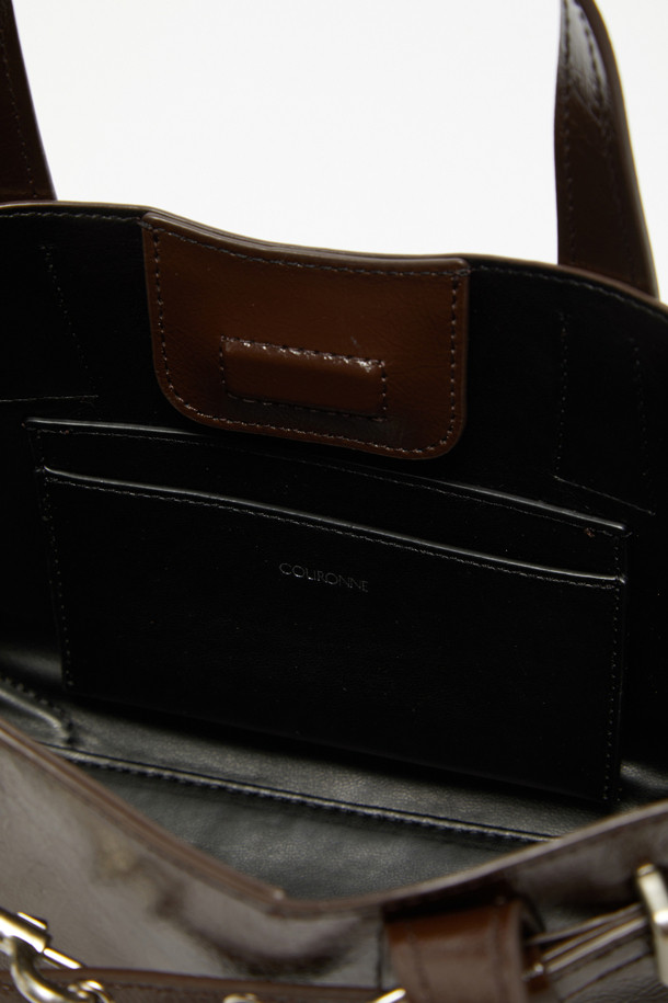 Fermier Day 토트 27은 미디엄 사이즈의 여성용 토트백입니다. 광택감 있는 합성가죽 소재에 버클 장식으로 미니멀하면서도 클래식한 무드를 연출합니다. 3-way 착용이 가능하며, iPad 11인치 수납이 가능한 실용적인 디자인으로, 내부 포켓과 조절 가능한 스트랩을 갖추었습니다. 브라운 컬러에 실버 하드웨어의 조화가 세련된 실루엣을 완성하여 출근룩, 오피스룩 등 다양한 스타일에 시크하게 매치할 수 있습니다. 버클형 잠금 방식으로 소지품을 안전하게 보관할 수 있습니다.
