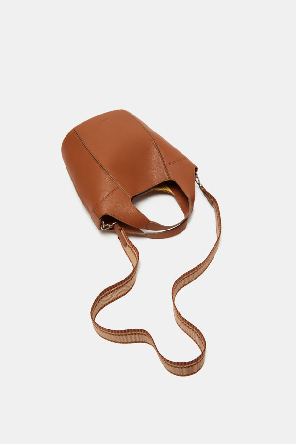 Teaberry Tote 17 Webbing (티베리 토트 17 웨빙)은 여성용 토트백입니다. 합성가죽 소재의 미디엄 사이즈 가방으로, 브라운 색상의 무지 디자인이 특징입니다. 반원 모양에 지퍼형 잠금 방식을 적용했으며, 숄더 스트랩이 있어 크로스백으로도 활용 가능합니다. 클래식, 미니멀, 시크 스타일을 선호하는 오피스룩, 출근룩, 모임룩에 잘 어울리는 가방입니다.
