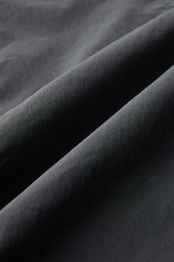 다크그레이 컬러의 탈부착 패딩 재킷입니다. 나일론과 폴리에스테르 혼방 소재로 제작되어 겨울철에도 따뜻하게 착용 가능하며, 오버핏으로 편안한 착용감을 선사합니다. 탈부착 가능한 소매 디자인으로 다양한 스타일 연출이 용이하며, 하이넥 디자인과 YKK 2-Way 지퍼, 스트링, 스토퍼 디테일이 특징입니다. 캐주얼, 미니멀, 시티보이 룩에 잘 어울리며, 출근룩과 여행룩 모두 소화 가능한 실용적인 아이템입니다.
