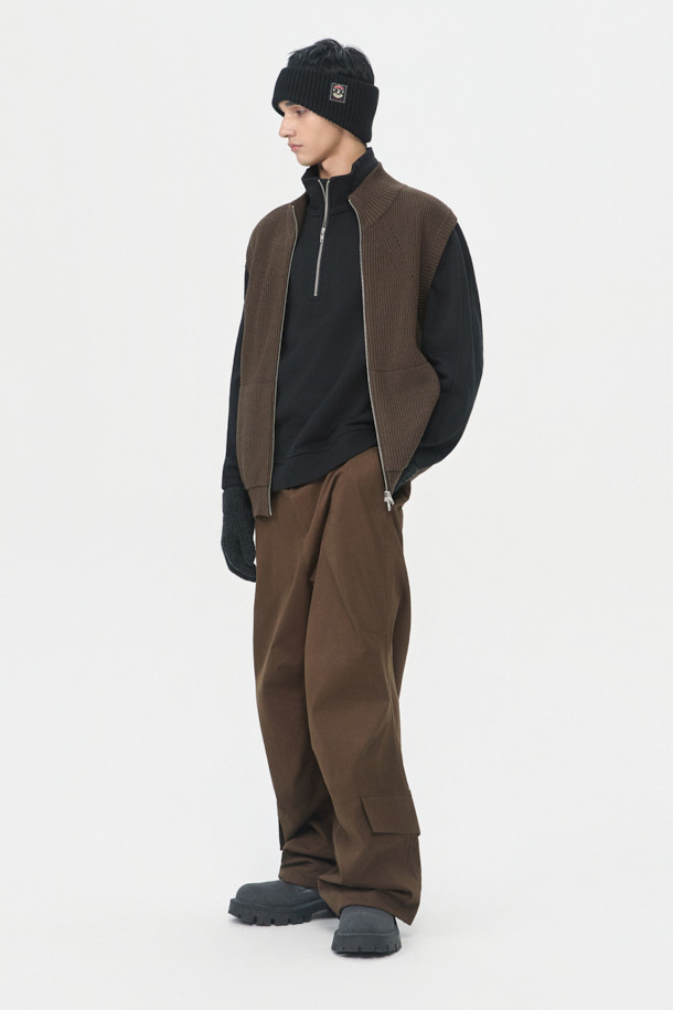 부드러운 촉감의 브라운 터틀넥 집업 베스트입니다. 면 60.2%와 울 39.8% 혼방 소재로 제작되어 간절기에 적합하며, 얇은 두께감으로 편안하게 착용할 수 있습니다. 12GG 골지 패턴으로 베이직한 스타일을 연출하며, 레귤러핏으로 다양한 스타일에 활용할 수 있습니다. 2-Way 지퍼 디테일이 돋보이며, 비즈니스 캐주얼 및 출근룩에 클래식하고 미니멀한 무드를 더해줍니다. 민소매 디자인으로 레이어드하기 좋습니다.
