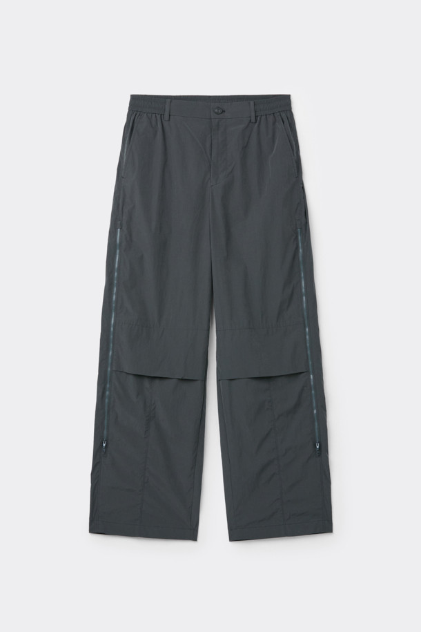 다크그레이 컬러의 Grey 사이드 지퍼 디테일 팬츠입니다. 나일론과 폴리에스테르 혼방 소재로 제작되어 사계절 내내 착용 가능하며, 은은한 광택감이 특징입니다. 와이드핏으로 편안한 착용감을 선사하며, 앞뒤 절개 디테일과 사이드 2-Way 지퍼 디테일로 포인트를 더했습니다. 하프 밴딩과 스트링으로 허리 조절이 용이하며, 출근룩, 비즈니스 캐주얼, 미니멀, 스포티, 캐주얼 스타일 모두 소화 가능한 활용도 높은 아이템입니다.
