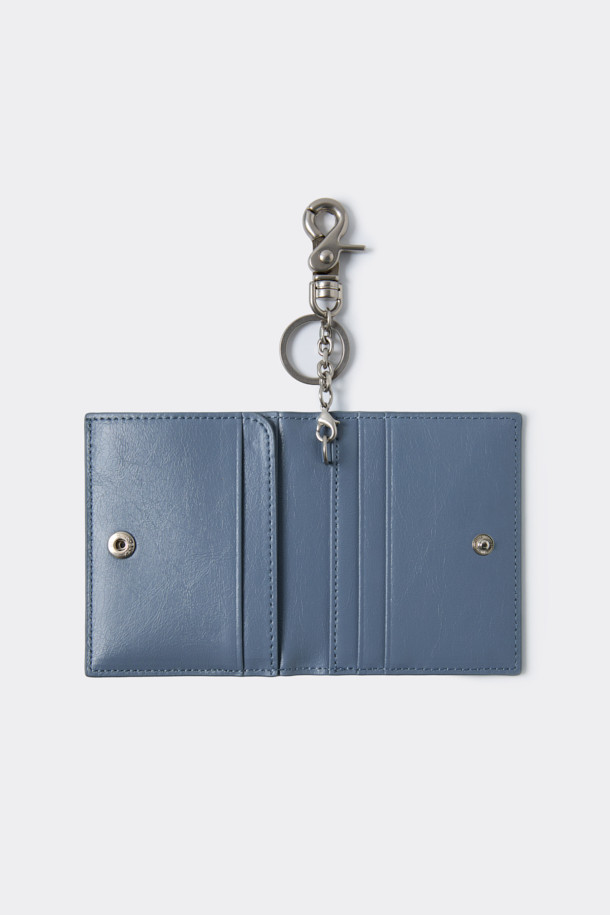 세련된 블루 컬러의 폴딩 카드지갑입니다. 미니 크링클 가죽과 합성피혁 소재로 제작되었으며, 미니멀한 디자인과 사각 쉐입이 특징입니다. 탈부착 가능한 키링과 좌우 4칸의 카드 포켓, 날개 오픈 포켓 1칸으로 실용성을 더했습니다. 데이트룩, 쇼핑룩, 카페룩 등 다양한 TPO에 미니멀, 클래식, 시크 스타일을 연출하기 좋은 아이템입니다. 로고 바 장식이 고급스러움을 더하는 컴팩트한 사이즈의 지갑입니다.
