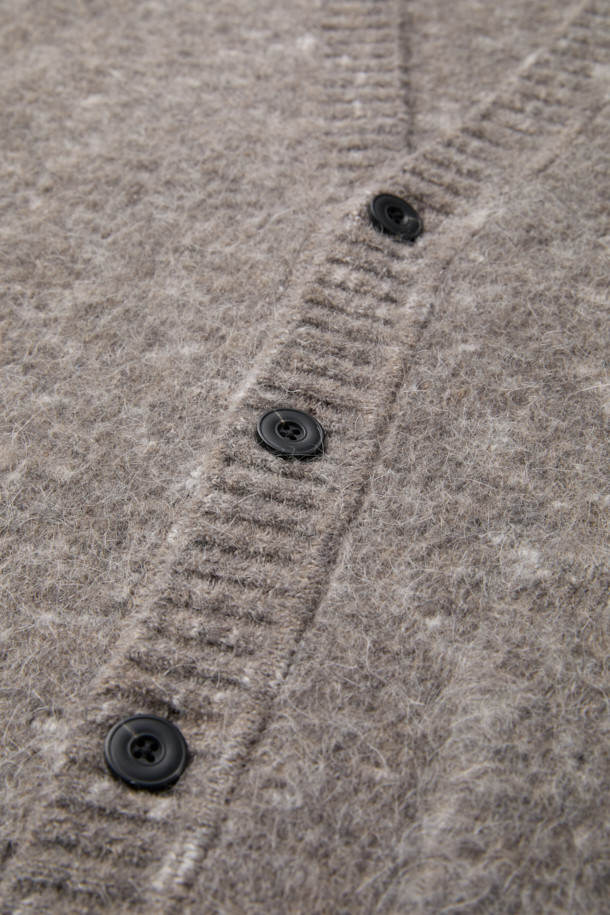 **Grey 모헤어 가디건**

부드러운 촉감의 그레이 컬러, 남성용 모헤어 가디건입니다. 릴랙스 핏에 브이넥 디자인으로 편안한 착용감을 선사하며, 가을/겨울 시즌에 적합합니다. 5GG 게이지, 멜란지 원사, 헤어리한 텍스처가 특징이며, 캐주얼, 미니멀, 클래식 스타일을 소화합니다. 출근룩과 모임룩 등 다양한 TPO에 활용 가능하며, 두꺼운 두께감으로 따뜻하게 착용할 수 있습니다. 아크릴, 나일론, 울, 모헤어, 폴리우레탄 혼방 소재로 제작되었습니다.
