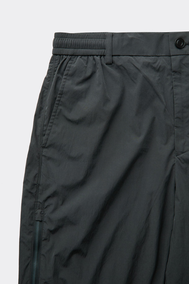 다크그레이 컬러의 Grey 사이드 지퍼 디테일 팬츠입니다. 나일론과 폴리에스테르 혼방 소재로 제작되어 사계절 내내 착용 가능하며, 은은한 광택감이 특징입니다. 와이드핏으로 편안한 착용감을 선사하며, 앞뒤 절개 디테일과 사이드 2-Way 지퍼 디테일로 포인트를 더했습니다. 하프 밴딩과 스트링으로 허리 조절이 용이하며, 출근룩, 비즈니스 캐주얼, 미니멀, 스포티, 캐주얼 스타일 모두 소화 가능한 활용도 높은 아이템입니다.
