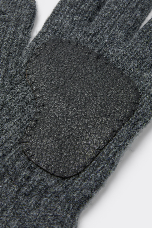 그레이 립 니트 글러브는 울, 나일론, 염소가죽 혼방 소재로 제작되어 보온성을 높인 공용 장갑입니다. 클래식한 스타일의 이 장갑은 골지 패턴에 핸드메이드 패치와 로고 디자인 장식이 더해져 섬세함을 더합니다. 핑거홀이 있어 스마트폰 터치가 가능하며, 출근룩과 모임룩에 모두 잘 어울립니다. 미니멀한 디자인으로 다양한 스타일에 매치하기 용이합니다.
