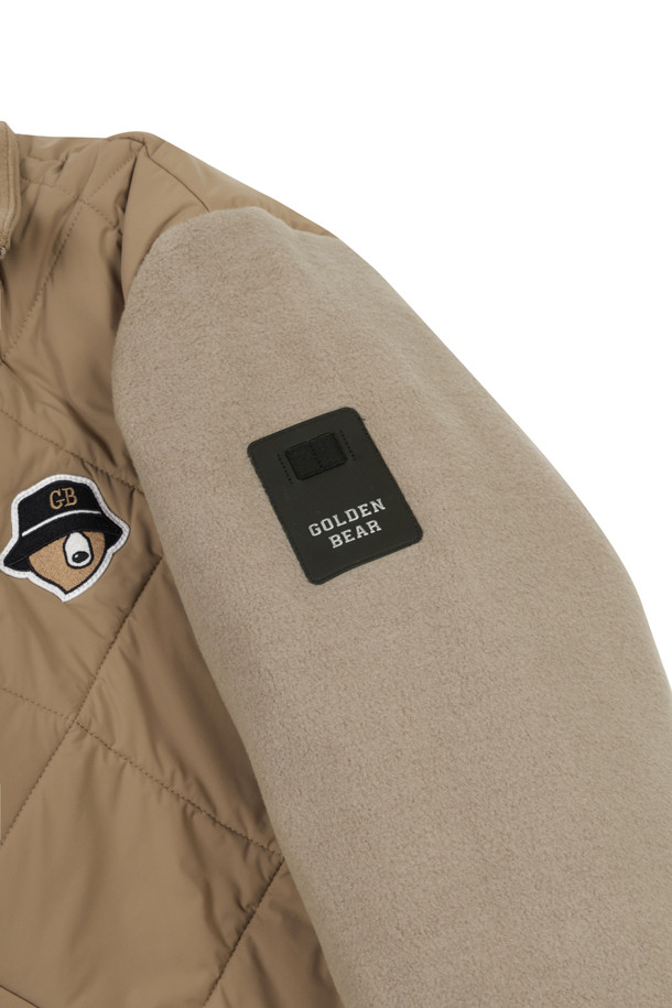 남성용 퀼티드 하이브리드 재킷입니다. 베이지 색상으로, 가을과 겨울에 따뜻하게 입을 수 있습니다. 골프 및 일상용으로 모두 활용 가능하며, 스포티하면서도 캐주얼한 스타일을 연출합니다. 폴리에스테르 소재로 제작되어 부드러운 촉감을 제공하며, 두꺼운 두께감으로 보온성을 높였습니다. 레귤러핏에 긴 소매, 집업 여밈 방식의 퀼팅 코트 타입 하이브리드 디자인입니다.
