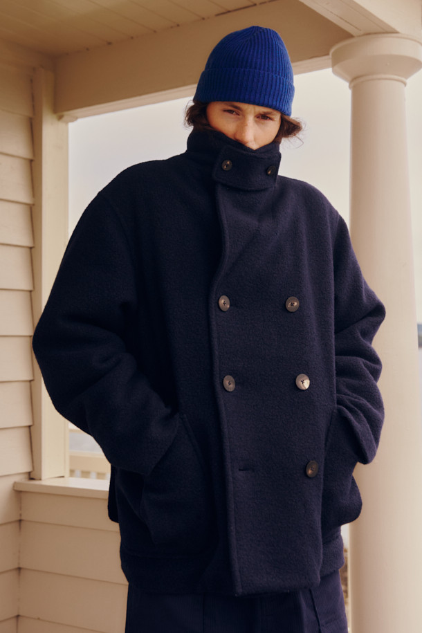 FFC x DOCUMENT(에프에프씨 x 도큐먼트) 울 부클 패디드 피코트는 클래식한 디자인의 겨울 아우터입니다. 겉감은 부드러운 부클레 텍스처의 울 소재로 제작되었으며, 네이비 컬러로 출시되었습니다. 루즈핏으로 편안한 착용감을 제공하며, 더블 버튼 여밈 방식과 긴 소매 기장이 특징입니다. 프리마로프트 충전재를 사용하여 높은 보온성을 자랑하며, 본딩 처리된 폴리에스터 안감으로 착용감을 높였습니다. 겨울 데일리룩, 출근룩, 모임룩 등 다양한 TPO에 맞춰 미니멀하고 시크한 스타일을 연출할 수 있습니다.
