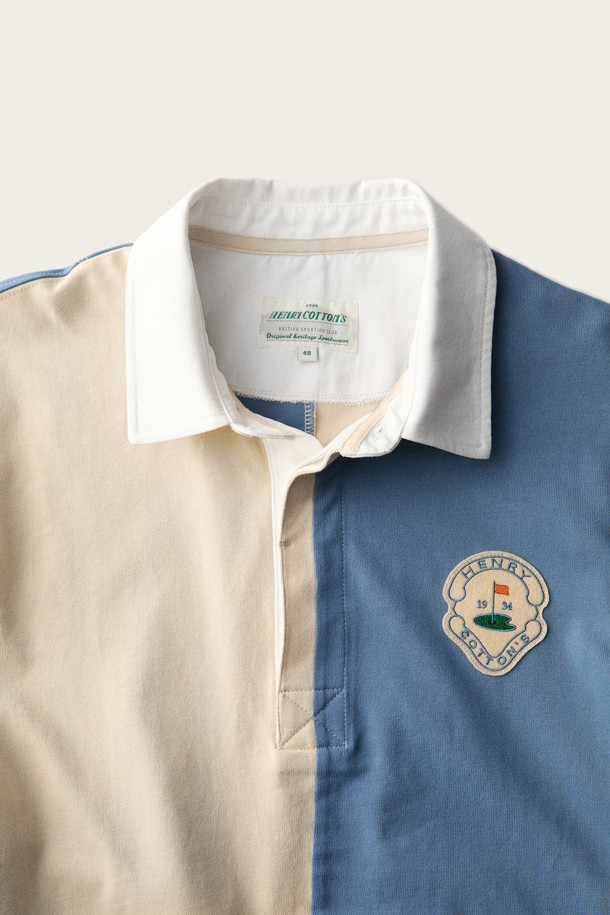 **브리티시 스포팅 클럽 플래드 긴소매 티셔츠**는 남성용 폴로 티셔츠로, 가을 시즌 일상복으로 적합합니다. 네이비, 베이지 색상으로 만나볼 수 있으며, 클래식과 스포티한 무드를 동시에 연출합니다. 면 소재로 제작되어 부드러운 촉감이 특징이며, 4분할 배색의 패치워크 패턴이 돋보입니다. 립 마감 처리와 B.S.C 로고, 펠트 소재 아플리케 아트워크 디테일이 돋보이며, 데이트룩, 모임룩, 캐주얼 스타일에 매치하기 좋습니다. 클래식 핏의 긴소매 폴로 티셔츠입니다.
