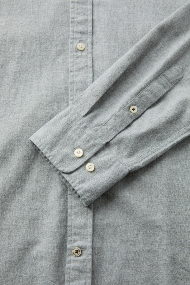 **트윌 솔리드 셔츠 (레귤러핏)**는 가을, 겨울에 착용하기 좋은 남성용 상의입니다. 비즈니스 캐주얼, 출근룩, 회의룩 등 다양한 TPO에 활용 가능하며, 클래식, 미니멀 스타일을 연출하기에 적합합니다. 면 소재의 긴소매 셔츠로, 레귤러핏과 버튼다운 칼라 디자인이 특징입니다. 그레이 컬러의 무지 패턴으로, 가슴 로고 자수와 카라 버튼 다운, 뒷면 요크 주름 디테일이 돋보입니다. 
