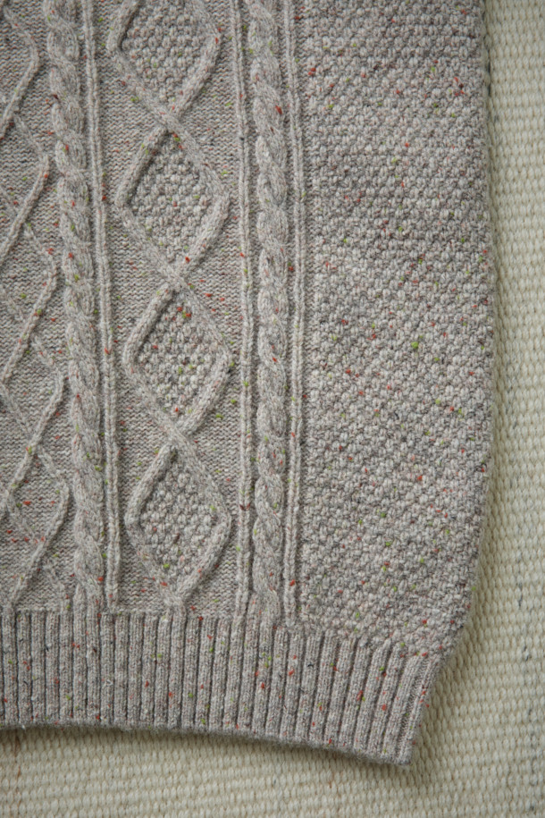 [Fly Fishing Club] 아란 스웨터는 아일랜드 아란 제도의 전통 니팅 스타일을 현대적으로 재해석한 제품입니다. 울과 나일론 혼방 소재로 제작되어 가을, 겨울에 따뜻하게 착용할 수 있으며, 루즈핏 레귤러 기장으로 편안한 착용감을 선사합니다. 입체적인 케이블 및 다이아몬드 무늬와 벌집 조직이 돋보이며, 울 네프 원사를 사용하여 빈티지하면서도 클래식한 분위기를 연출합니다. 립 조직 네크라인과 긴 소매 디자인으로 보온성을 높였으며, 10월부터 2월까지 겨울 데일리룩, 카페룩, 모임룩 등 다양한 스타일에 활용 가능합니다. 가슴둘레 122cm로 넉넉한 핏을 제공합니다.
