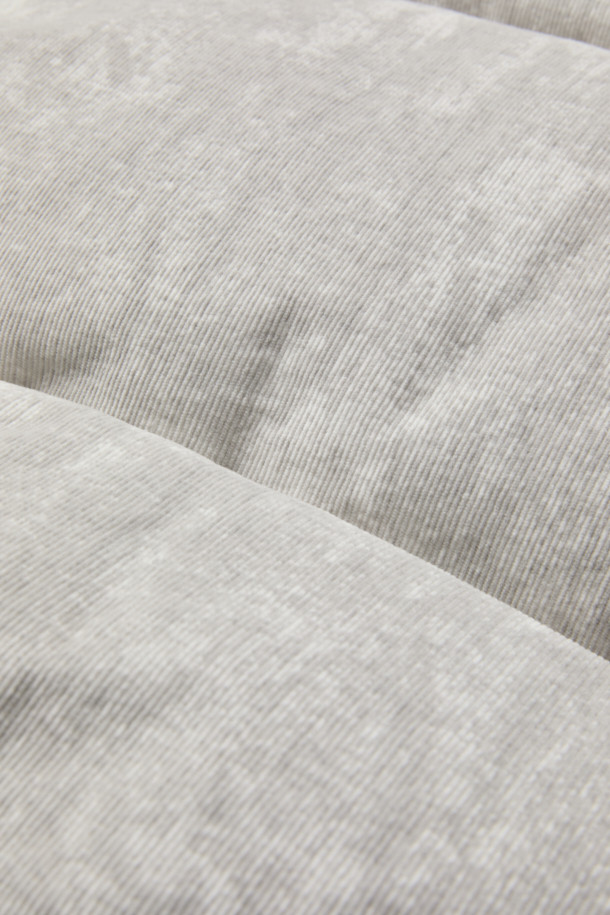 TOSCANA(토스카나) 코듀로이 패턴 구스다운 하이넥 점퍼는 미니멀한 스타일을 추구하는 분들을 위한 겨울철 필수 아이템입니다. 부드러운 코듀로이 소재에 은은한 프린트 패턴을 더해 세련된 외관을 자랑하며, 90/10 구스다운 충전재로 뛰어난 보온성을 제공합니다. 하이넥 디자인과 안쪽 시보리 디테일은 찬 바람을 효과적으로 막아주며, 오버핏으로 편안한 착용감을 선사합니다. 집업 스타일로 간편하게 입고 벗을 수 있으며, 일상생활에서 캐주얼하고 클래식한 스타일을 연출하기 좋습니다.
