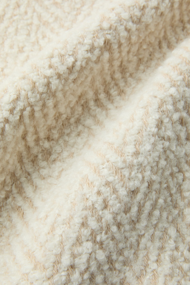 SANABSPE(사나스페) 하이넥 부클 코트는 가을, 겨울 시즌에 어울리는 오버핏 니트 코트입니다. 아이보리, 베이지 두 가지 색상으로 출시되었으며, 부드러운 촉감의 모, 아크릴, 폴리에스터, 나일론, 레이온 혼방 소재로 제작되었습니다. 하이넥 디자인과 집업 여밈 방식으로 보온성을 높였으며, 플랫 포켓과 사이드 히든 포켓으로 실용성을 더했습니다. 출근룩, 모임룩 등 다양한 TPO에 클래식, 미니멀, 캐주얼 스타일로 연출하기 좋습니다. 안감은 레이온과 면으로 마감되어 편안한 착용감을 선사합니다.
