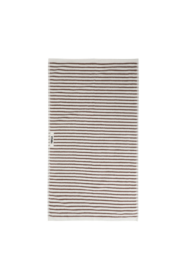 테리 핸드 타월 (세일러 스트라이프) 50X90 - 코디악 스트라이프는 부드러운 면 소재로 제작되어 뛰어난 흡습력을 자랑하는 욕실용 타월입니다. 화이트와 브라운 컬러의 세일러 스트라이프 패턴이 시원하고 산뜻한 분위기를 연출합니다. 보통 두께감으로 제작되었으며, 부드러운 촉감이 특징입니다. 깔끔한 디자인을 위해 더블 스티치 처리된 밑단과 견고한 모서리 마감, 행거 루프가 적용되었습니다. Oeko-Tex® Standard 100 인증을 받아 안심하고 사용할 수 있습니다.
