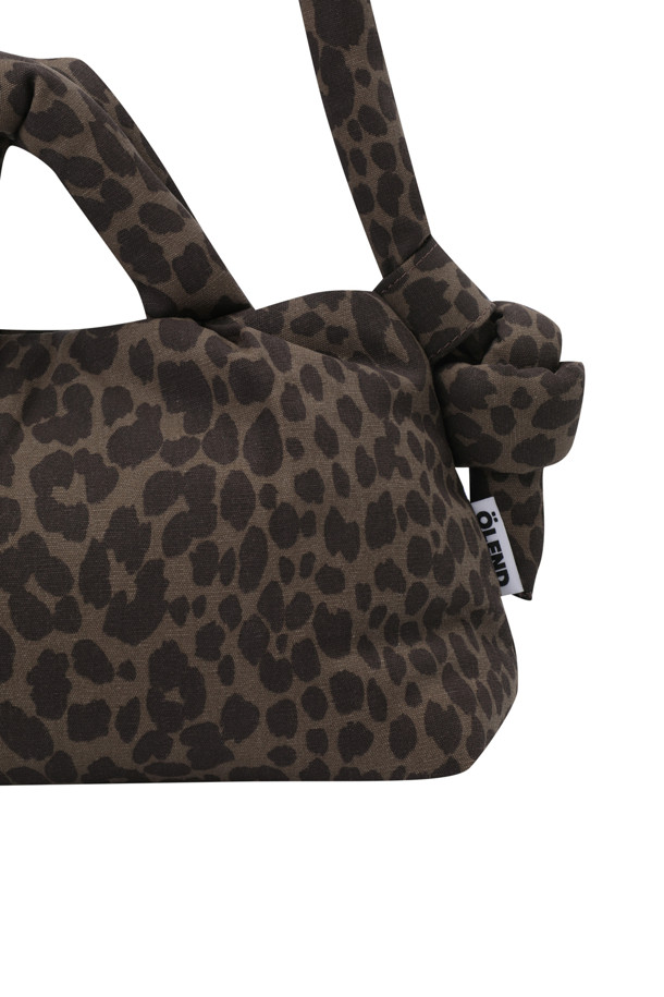 MINI ONA SOFT BAG - 레오파드
브라운과 블랙 컬러의 레오파드 패턴이 돋보이는 여성용 미니백입니다. 스몰 사이즈로, 데이트룩, 카페룩, 모임룩 등 다양한 TPO에 맞춰 클래식, 미니멀, 캐주얼 스타일을 연출할 수 있습니다. 가볍고 푹신한 착용감이 특징이며, 스트랩 조절이 가능하여 편리합니다. 자석형 및 지퍼형 잠금 방식으로 내용물을 안전하게 보관할 수 있으며, 내부 포켓 2개와 외부 지퍼 포켓 1개로 수납력을 높였습니다. 스트랩은 최대 100cm까지 조절 가능합니다.
