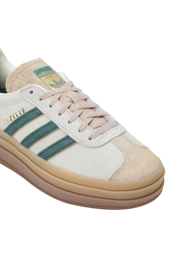 가젤 볼드 슈즈는 크림 화이트, 콜리제이트 그린, 매직 베이지 세 가지 색상으로 출시된 여성 스니커즈입니다. 스웨이드 소재로 제작되어 부드러운 질감을 자랑하며, 일상에서 편안하게 착용할 수 있습니다. 캐주얼, 미니멀, 클래식 스타일을 모두 소화하여 동네 마실룩이나 산책룩에 잘 어울립니다. T-토 디자인과 세 개의 층으로 구성된 두툼한 검 러버 아웃솔이 돋보이며, 레귤러 핏으로 제작되어 편안한 착용감을 제공합니다. 안감은 합성 소재로 마감되었습니다.
