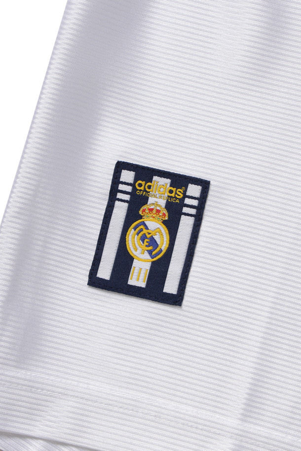 레알 마드리드 99/00 홈 유니폼 - 화이트는 남성용 스포츠 의류입니다. 봄, 여름 시즌에 적합하며, 스포티하고 클래식한 스타일을 연출합니다. 헨리넥 디자인에 루즈핏으로 편안하게 착용 가능하며, 반소매 기장과 로고 패턴이 특징입니다. 레트로 축구 유니폼으로, 자수 로고가 돋보이는 디자인입니다. 피트니스룩, 휴가룩, 여행룩 등 다양한 TPO에 활용할 수 있습니다.
