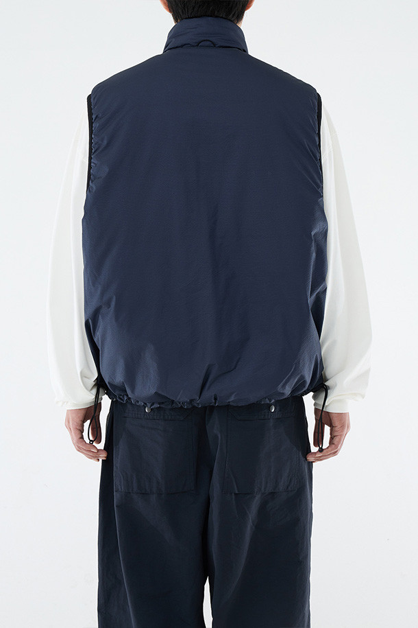 **REVERSIBLE PUFF VEST - CLOUD GRAY/NAVY (리버서블 패딩 베스트 - 클라우드 그레이/네이비)**

클라우드 그레이와 네이비 컬러 양면으로 착용 가능한 남성용 리버서블 패딩 베스트입니다. 가을, 겨울 시즌에 적합하며, 캐주얼 및 스포티 스타일을 연출할 수 있습니다. 넉넉한 루즈핏으로 편안한 착용감을 제공하며, 지퍼형 여밈과 스탠드 카라 디자인으로 보온성을 높였습니다. 방수, 보온, 통기 기능에 신슐레이트 충전재를 사용하여 한겨울에도 따뜻하게 입을 수 있습니다. 일상, 산책, 여행 등 다양한 TPO에 활용하기 좋은 아이템입니다.
