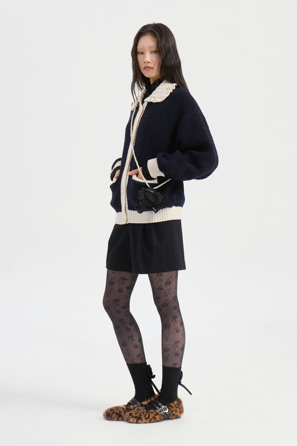 다크 네이비 컬러의 Colored Collar 니트 풀오버입니다. 부드러운 울 소재로 제작되어 가을과 겨울에 따뜻하게 착용할 수 있습니다. 페미닌하고 캐주얼한 무드를 연출하며, 루즈핏과 긴 소매 기장으로 편안함을 더했습니다. 배색 프릴 카라와 금속 버튼, 앞 포켓, 뒷면 그래픽 디자인이 특징입니다. 데이트룩, 모임룩, 캐주얼, 클래식, 미니멀 스타일 모두 소화 가능한 아이템입니다.
