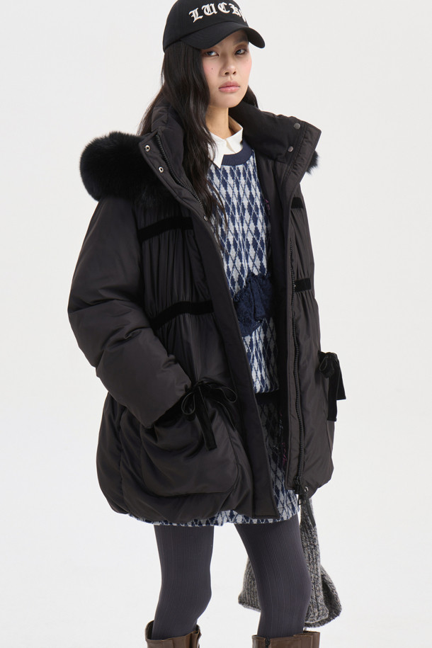 블랙 컬러의 폭스 퍼 트리밍 후드 다운 점퍼입니다. 여성스러운 페미닌 및 러블리 무드를 연출하며, 세미 A라인 핏으로 날씬한 실루엣을 선사합니다. 부드러운 구스다운 소재와 두꺼운 두께감으로 뛰어난 보온성을 제공하며, 탈부착 가능한 폭스 퍼 트리밍, 벨벳 리본 및 셔링 디테일이 고급스러움을 더합니다. 럭키 로고 패턴 안감과 긴 소매 기장, 집업 여밈 방식으로 편안한 착용감을 선사하며, 데이트룩, 모임룩, 연말 모임룩 등 다양한 TPO에 활용 가능합니다. 클래식, 로맨틱, 미니멀 스타일을 즐기는 여성분들께 추천합니다.

