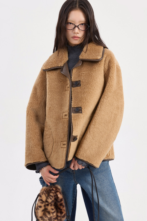 포근하고 부드러운 페이크 퍼 소재의 카멜 컬러 점퍼입니다. 캐주얼, 미니멀, 클래식 스타일을 아우르며, 가을, 겨울 시즌 데이트룩, 모임룩에 활용하기 좋습니다. 크롭 기장에 루즈핏 또는 오버핏으로 연출 가능하며, 2WAY 착용 가능한 리버시블 디자인과 아웃포켓, 페이크 레더 파이핑 디테일이 특징입니다. 긴 소매에 버튼 여밈 방식으로 편안하게 착용할 수 있습니다. 두께감 있는 소재로 따뜻함과 스타일을 동시에 잡아보세요.
