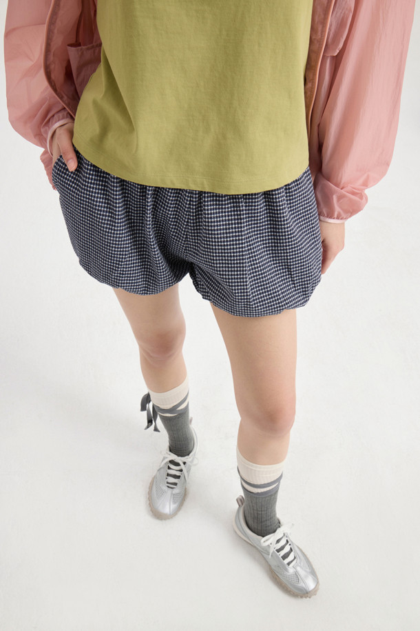 LUCKY CHOUETTE (럭키슈에뜨)의 Chouetties Check Volume Shorts (체크 볼륨 쇼츠) 입니다. 블루 컬러의 여성 숏팬츠로, 캐주얼하고 여성스러운 스타일을 연출합니다. 허리 밴딩과 밑단 밴딩으로 편안한 착용감을 선사하며, 셔링 디테일과 볼륨감 있는 디자인이 특징입니다. 체크 패턴이 돋보이며, 뒷면 라벨 장식으로 포인트를 더했습니다. 동네 마실룩, 카페룩, 봄 소풍룩 등 다양한 TPO에 활용하기 좋은 아이템입니다.
