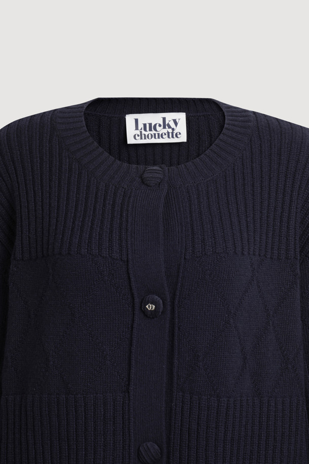 라운드 넥 하프 니트 가디건 (다크 네이비)은 울, 나일론, 캐시미어 혼방 소재로 제작되어 부드러운 촉감과 따뜻함을 선사합니다. 라운드 넥 디자인과 긴 소매 기장, 루즈핏으로 편안한 착용감을 제공하며, 가을, 겨울 시즌 데일리룩, 카페룩, 모임룩에 모두 잘 어울립니다. 클래식, 캐주얼, 미니멀 스타일을 연출하기 좋으며, 하프 기장으로 다양한 하의와 매치하기 용이합니다. 코듀로이 단추 디테일과 빅 아웃포켓이 특징이며, 원피스 위에 레이어드하여 스타일리시하게 연출할 수도 있습니다.
