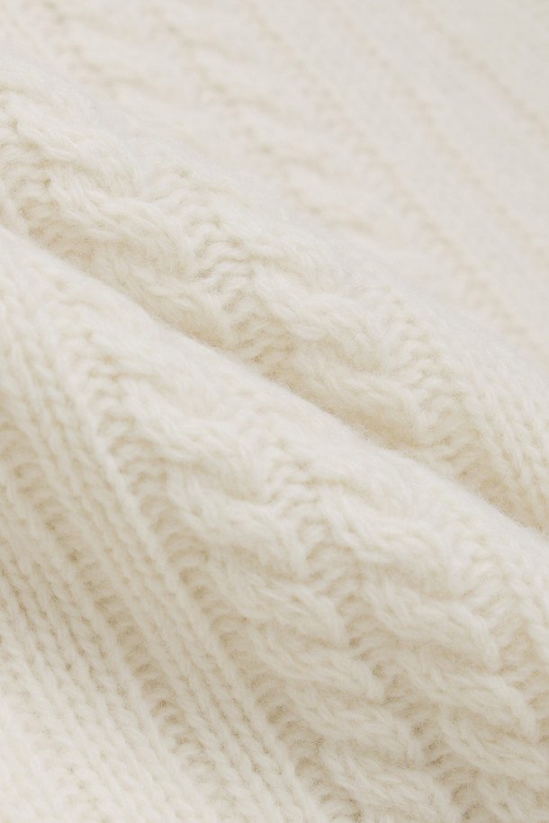 **Ribbon Knit Skirt (아이보리)**

부드러운 메리노울 소재의 리본 니트 스커트입니다. 세미 A라인 핏과 맥시 기장으로 우아한 실루엣을 연출하며, 케이블 및 립조직 패턴이 고급스러운 분위기를 더합니다. 밑단 립조직과 리본 디테일이 돋보이며, 두꺼운 두께감으로 따뜻하게 착용 가능합니다. 가을, 겨울 시즌 데이트룩, 모임룩, 출근룩 등 다양한 TPO에 활용 가능하며, 클래식, 미니멀, 걸리시 스타일을 즐기는 여성분들께 추천합니다. 체형 커버에도 효과적이며 세트업으로도 활용할 수 있습니다.
