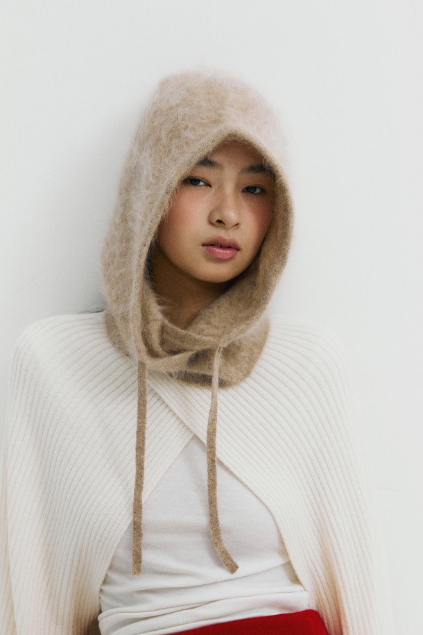 베이지 컬러의 헤어리 캐시미어 바라클라바입니다. 부드러운 촉감의 캐시미어 소재에 브러싱 처리를 더해 포근함을 높였습니다. 깊은 모자 깊이와 후드형 디자인으로 보온성을 극대화하며, 스트링으로 핏 조절이 가능합니다. 겨울철 데일리룩, 산책룩, 집콕룩 등 다양한 TPO에 활용 가능하며, 넥워머로도 사용할 수 있습니다. 미니멀, 클래식, 캐주얼 스타일을 즐겨 입는 분들께 추천합니다.
