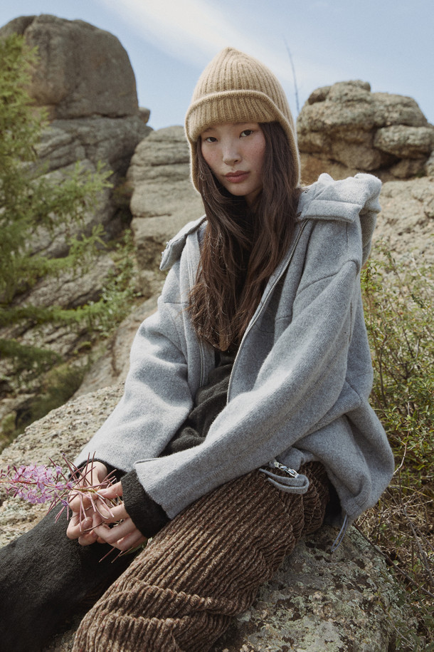 그레이 컬러의 더블 페이스드 재킷입니다. 울과 캐시미어 혼방 소재로 제작되어 부드러운 촉감과 뛰어난 보온성을 제공하며 가을, 겨울 시즌에 착용하기 좋습니다. 오버핏으로 디자인되어 편안한 착용감을 선사하며, 큼직한 후드와 밑단 스토퍼 디테일이 특징입니다. 양면 이중직으로 제작되어 볼륨감 있는 실루엣을 연출하며, 동그란 소매 라인으로 포인트를 더했습니다. 출근룩, 모임룩 등 다양한 TPO에 캐주얼, 클래식, 미니멀 스타일로 활용하기 좋습니다.
