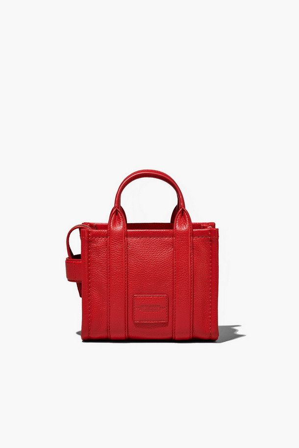 Leather Tote The Mini Tote_True Red (레더 토트 더 미니 토트_트루 레드)는 소가죽 소재의 미니 토트백입니다. 탈부착 및 길이 조절 가능한 스트랩과 상단 핸들을 갖춰 다양한 스타일 연출이 용이하며, 사각 쉐입과 로고 패턴으로 시크한 매력을 더합니다. 가방 내부에는 지퍼 포켓이 있어 소지품을 안전하게 보관할 수 있으며, 더스트백이 함께 제공됩니다. 데이트룩, 쇼핑룩, 모임룩 등 폭넓은 TPO에 클래식, 미니멀, 시크한 스타일을 완성할 수 있습니다. 
