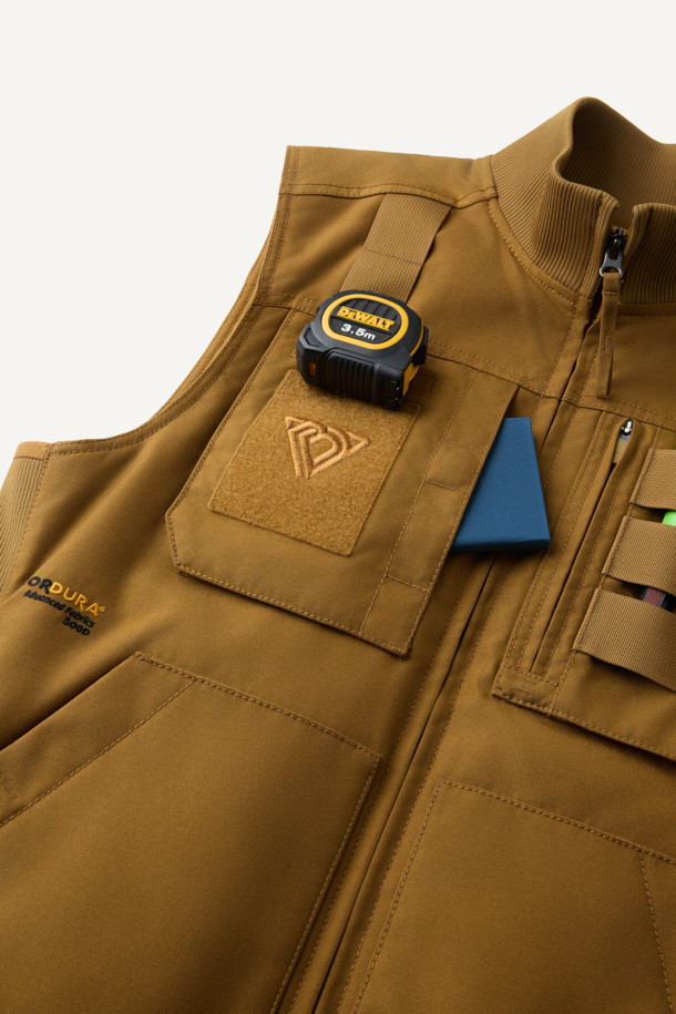 겨울철 일상과 아웃도어 활동에 적합한 헤비듀티 패딩 베스트입니다. 브라운 컬러의 무지 디자인으로, 유틸리티와 스포티한 스타일을 연출합니다. 겉감은 내구성이 뛰어난 코듀라와 나일론 소재를 사용하여 제작되었으며, 두꺼운 두께감으로 보온성을 높였습니다. 고기능성 패딩 충전재와 다수의 포켓, YKK 지퍼, 벨크로 포켓, 웨빙테이프 디테일 등 다양한 기능과 디자인 요소를 갖추었습니다. 내구성과 내마모성이 뛰어나며, 사이드 립 배색으로 포인트를 주어 세련된 겨울 데일리룩과 여행룩을 완성합니다.
