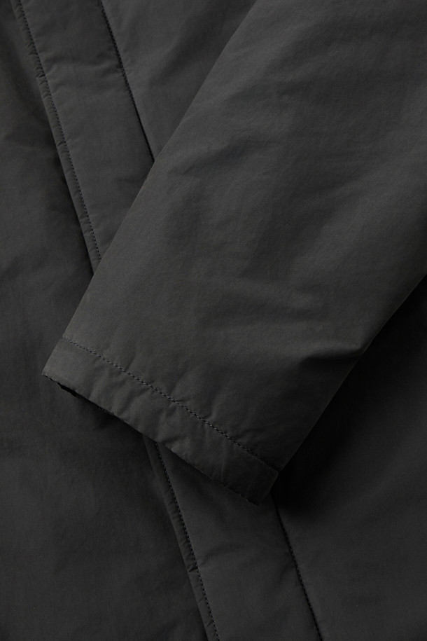 세련된 겨울 스타일을 완성하는 블랙 구스 코트입니다. 일상생활은 물론, 출근룩에도 잘 어울리는 미니멀하고 베이직한 디자인이 특징입니다. 롱 기장에 세미 오버핏으로 편안한 착용감을 선사하며, 지퍼형 여밈으로 간편하게 탈착용할 수 있습니다. 고밀도 나일론과 폴리에스테르 혼방 소재에 구스다운 충전재를 사용하여 뛰어난 보온성을 제공하며, 생활 방수 및 방풍 기능으로 추운 날씨에도 끄떡없습니다. 드롭 숄더 디자인과 퀼팅 안감으로 고급스러운 디테일을 더했습니다.
