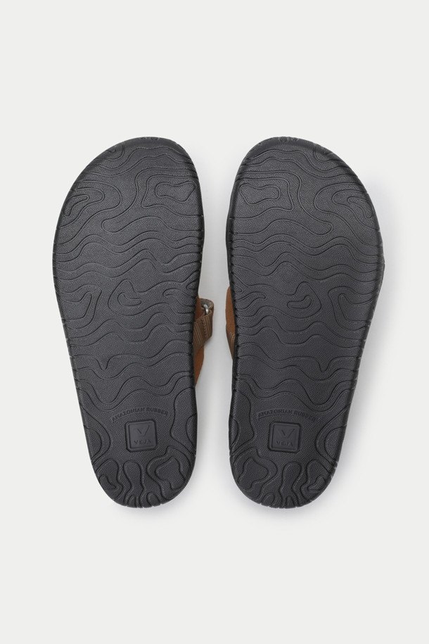 HOMECORE X VEJA 샌들은 브라운과 블랙 두 가지 색상으로 출시된 남성용 샌들입니다. 오픈토 디자인과 스트랩 여밈으로 편안하면서도 세련된 스타일을 연출합니다. 스웨이드, 고무, 가죽, 폴리에스테르 등 지속 가능한 소재를 사용하여 제작되었으며, 가죽 안감으로 부드러운 착용감을 선사합니다. 플랫 굽과 심플한 디자인은 휴가룩, 리조트룩, 여행룩 등 다양한 TPO에 활용하기 좋습니다. 발의 형태를 자연스럽게 따라가는 디자인과 스트랩으로 사이즈 조절이 가능하며, 미니멀, 캐주얼, 리조트 스타일을 즐기는 남성에게 완벽한 선택입니다.
