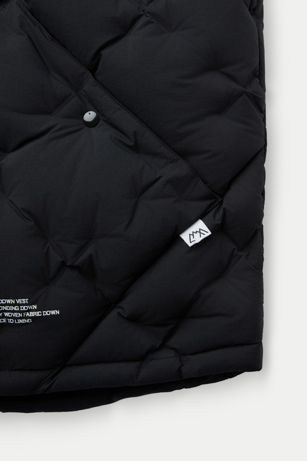 CMF 우븐 다운 베스트는 가을, 겨울철 일상과 출퇴근, 여행 시에 활용하기 좋은 다운 베스트입니다. CMF WOVEN 기술을 적용하여 다운팩 없이 다운 90%, 페더 10% (700FP)의 충전재를 다운 본딩 처리하여 보온성과 경량성을 동시에 잡았습니다. 미니멀한 스타일의 무지 디자인에 레귤러핏으로 제작되었으며, 집업 스타일과 크롭 기장, 민소매 디자인이 특징입니다. 블랙 색상으로 출시되어 다양한 룩에 매치하기 용이하며, 사선 포켓이 실용성을 더합니다.
